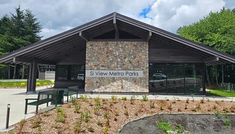 The new Si View Metro Parks Administration Building with a stone sign wall and fresh landscaping