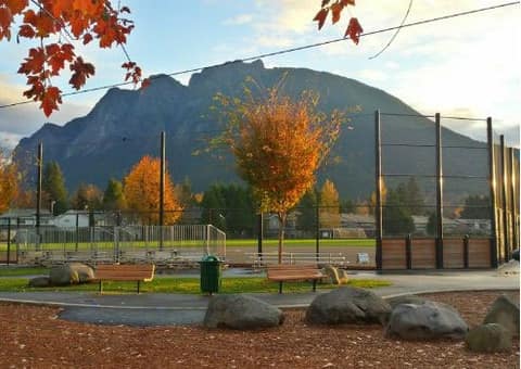 Mount Si above the Si View Park ballfield in autumn, with benches and boulders in the foreground